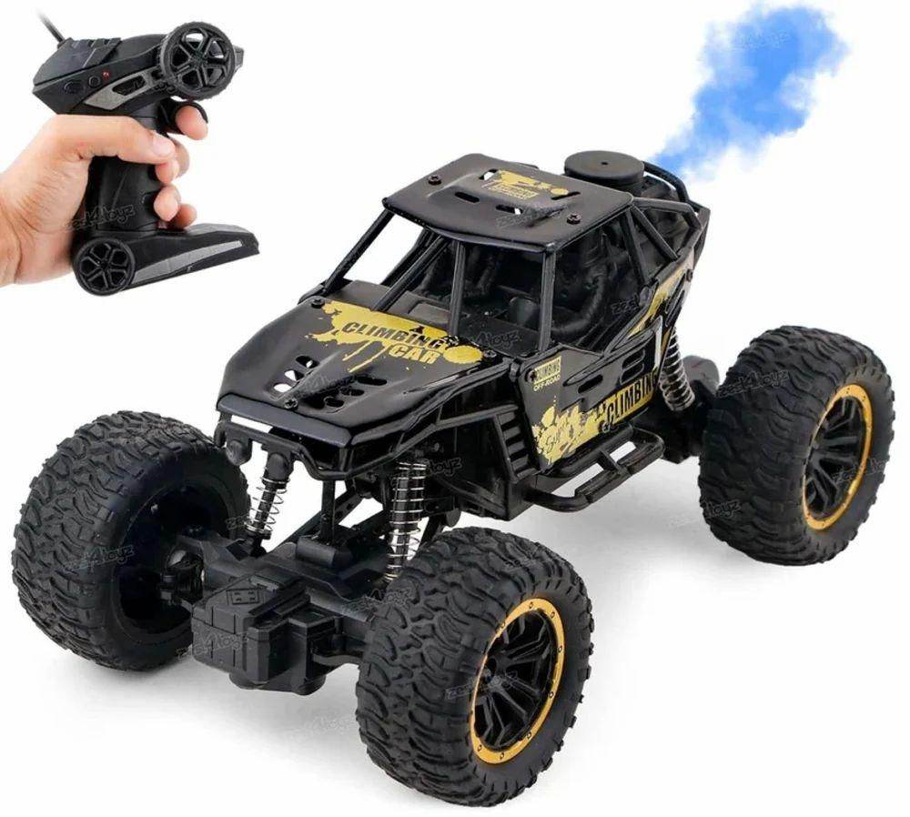 Black and gold remote control monster truck with a hand holding a remote control on a white background